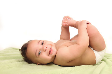 Image showing Infant Boy Holding His Foot on White Background