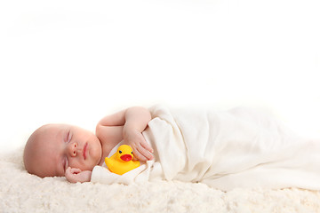 Image showing Swaddled Infant Holding a Rubber Duckie