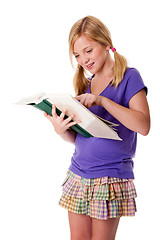 Image showing Happy school girl reading and learning