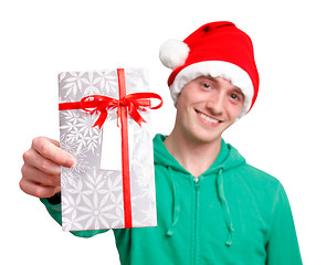 Image showing Man with santa hat holding christmas present