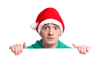 Image showing Guy with santa hat and sign
