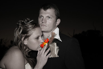 Image showing Bride smelling a flower