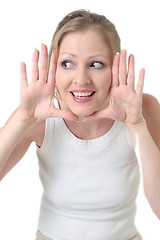 Image showing cute woman framing face with hands