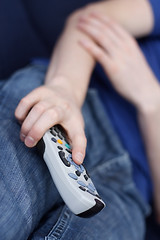 Image showing Guy watching tv with remote