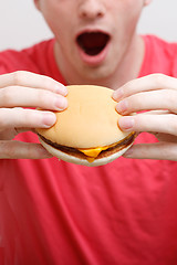 Image showing Man eating burger