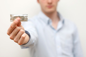 Image showing Man holding condom