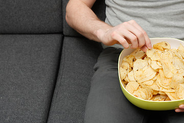 Image showing Man eating chips