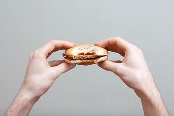 Image showing Man eating burger