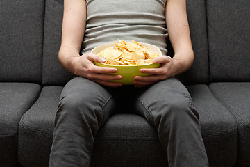 Image showing Man eating chips