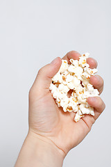 Image showing Hand holding popcorn