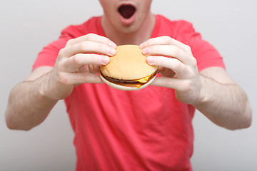 Image showing Man eating burger