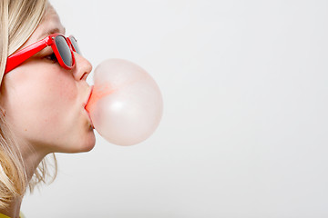 Image showing Girl playing with gum