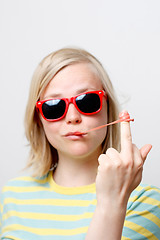 Image showing Girl playing with gum