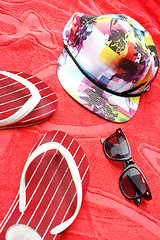 Image showing Flip flops, sunglasses and a cap