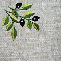 Image showing Embroidery of olive branch on linen beige fabric 