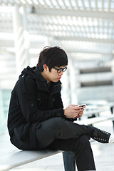 Image showing man texting on cell phone