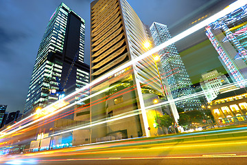 Image showing light trails on the modern building background in Hong Kong