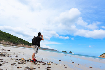 Image showing Photographer taking photo on beach