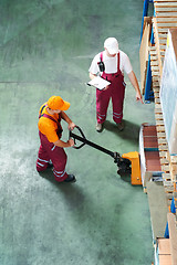 Image showing Warehouse workers with fork pallet truck stacker