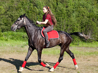 Image showing A girl riding a horse