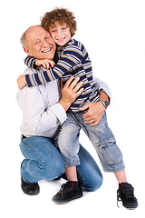 Image showing Grandson hugging his grandpa, indoors