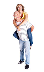 Image showing Senior man giving woman piggyback ride