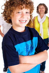Image showing Young cute boy in focus with family in the background