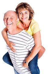 Image showing Senior man giving woman piggyback ride