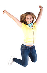 Image showing Girl jumping high with headphones around her neck