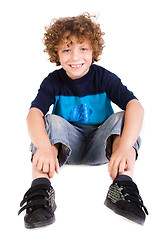 Image showing Adorable young kid sitting on floor