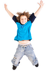 Image showing Young and attractive kid jumping high