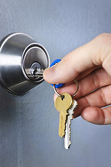 Image showing Hand inserting keys in lock