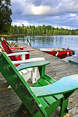 Image showing Deck chairs on dock at lake