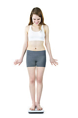 Image showing Fit young girl checking her weight