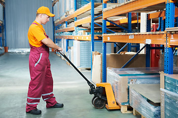 Image showing worker with fork pallet truck
