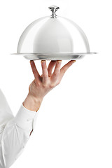 Image showing hand of waiter with cloche lid cover