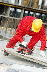 Image showing cutting construction wood board with grinder saw