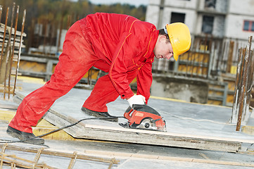 Image showing cutting construction wood board with grinder saw
