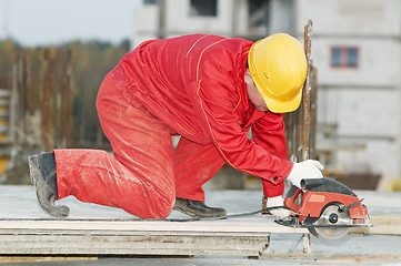 Image showing cutting construction wood board with grinder saw