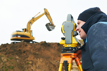 Image showing surveyor works with theodolite tacheometer