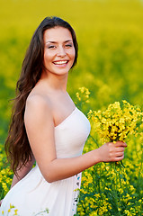 Image showing girl with flowers at summer field