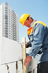 Image showing bricklayer at construction masonry works