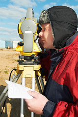 Image showing surveyor works with theodolite tacheometer