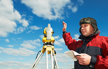 Image showing surveyor works with theodolite tacheometer