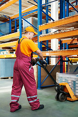 Image showing worker with fork pallet truck