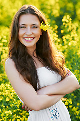 Image showing girl with flowers at summer field