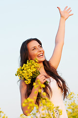 Image showing girl with flowers at summer field