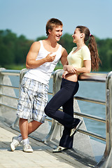 Image showing Young man and woman relaxing after jogging