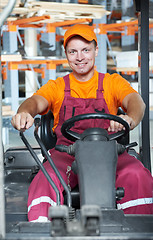 Image showing warehouse worker in forklift loader