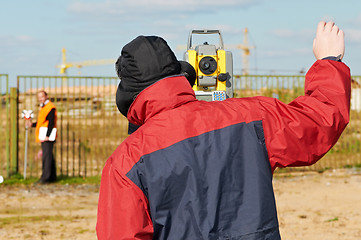 Image showing surveyor works with theodolite tacheometer